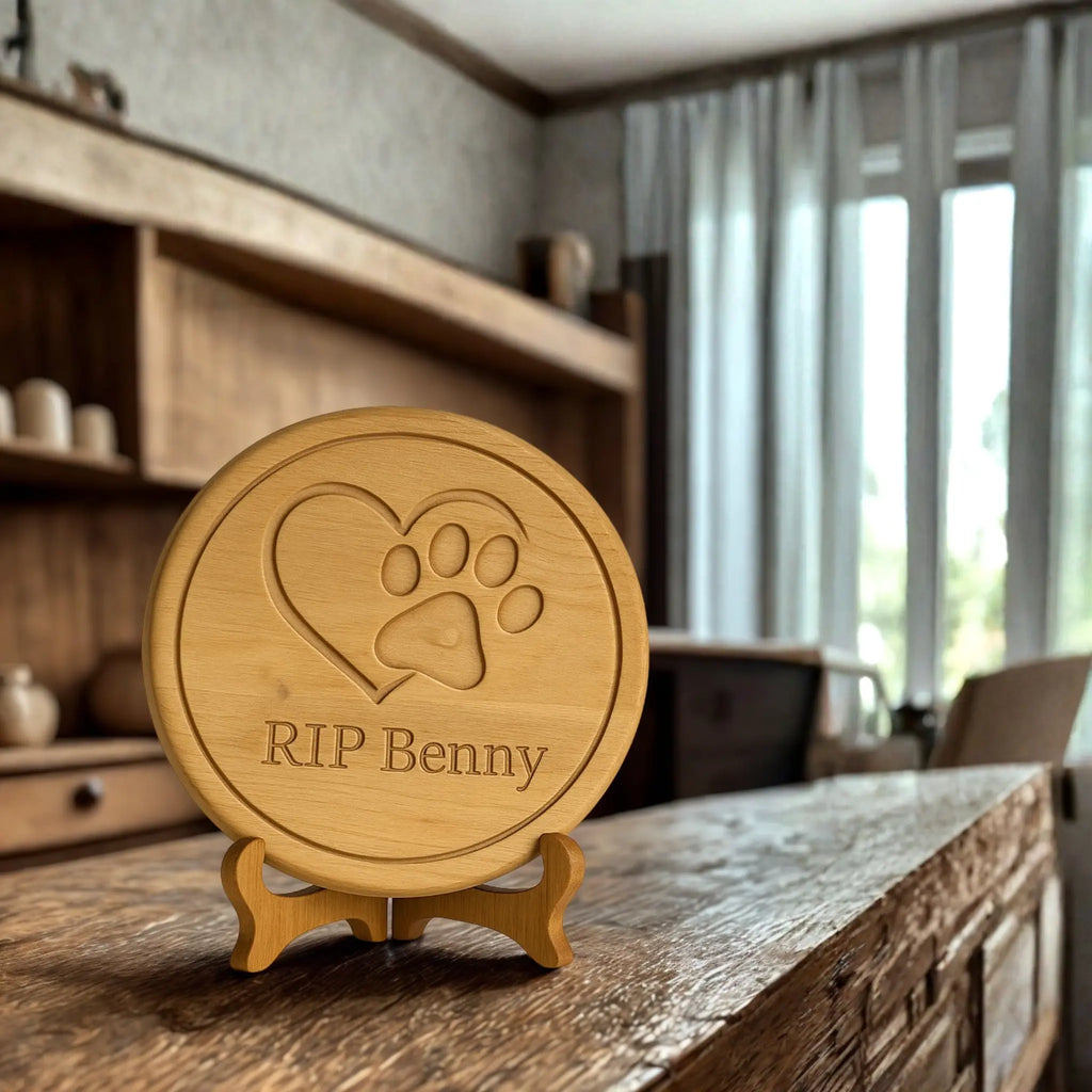 Wooden plaque with paw print and heart design on a stand, placed on a wooden surface.
