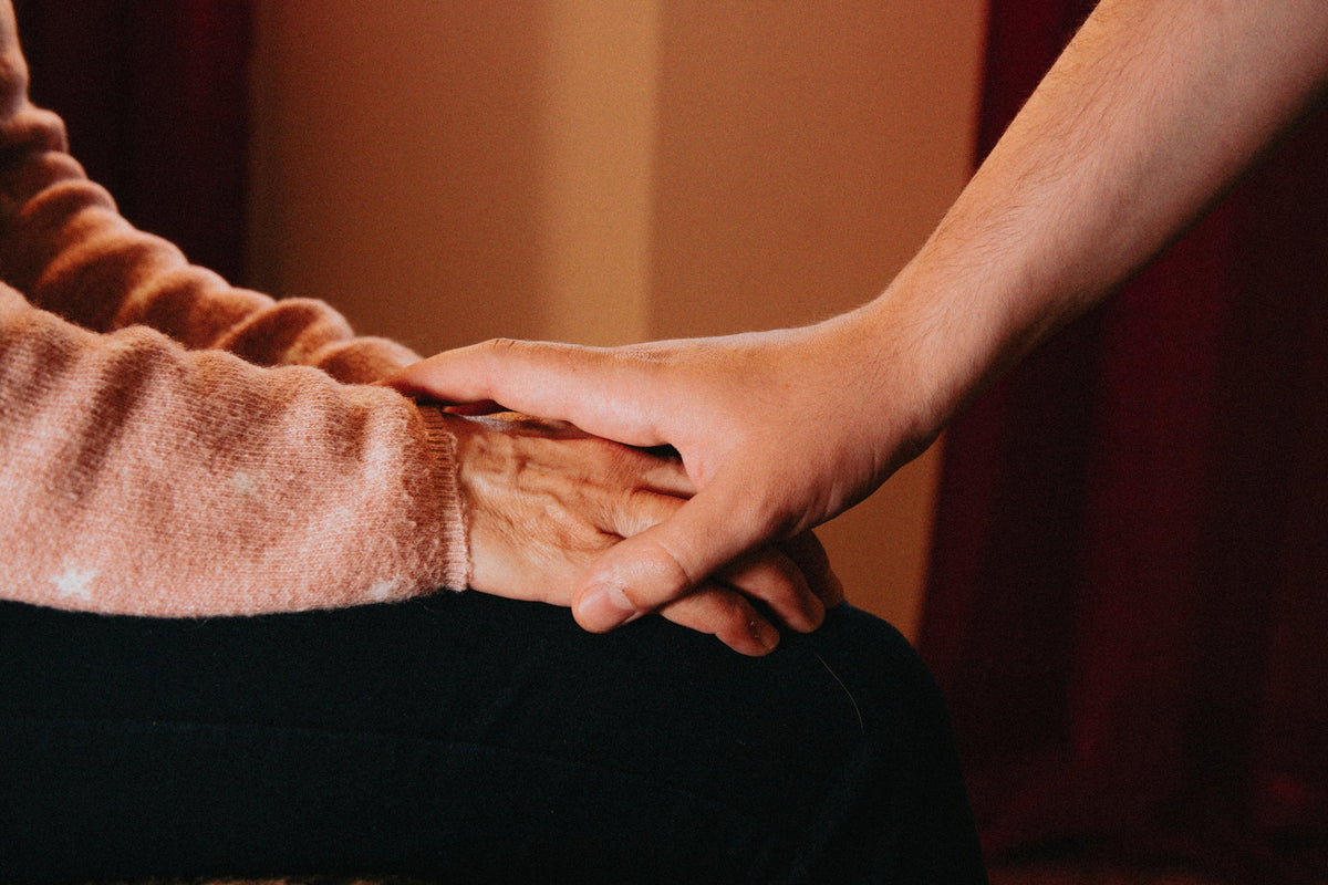hands rest on another persons hand